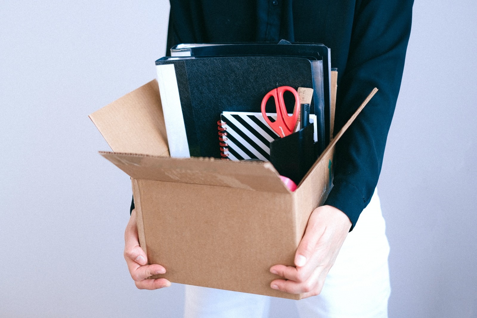 Someone holding a box of stationery